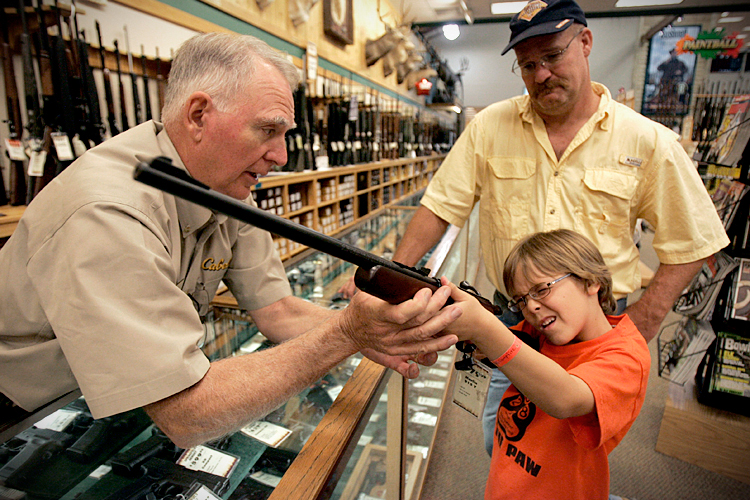 McConathy holds a hunting rifle with a short stock at the Cabela's store in Fort Worth